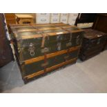 A large wooden bound/canvas Travel Trunk with metal mounts and corners