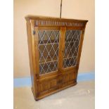 Old charm style medium Oak part glazed Bookcase with leaded Lights and Linen fold Panels 137cm