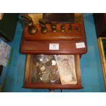 A set of 6 brass Bell Weights 1lb down to 1/2oz and a wooden drawer of mixed coins