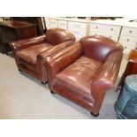 A pair of brown leather low back Armchairs