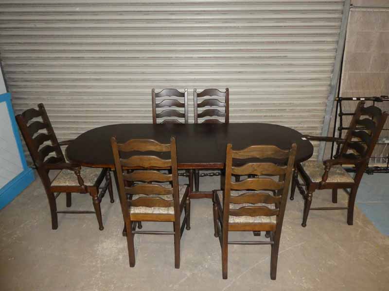 An Oak extending Dining table with six matching ladder back Chairs 195cm length