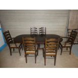 An Oak extending Dining table with six matching ladder back Chairs 195cm length