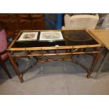 A cane and glass Conservatory Dining Table and two Japanese wood block Prints