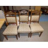 A trio of Edwardian Dining Chairs with stuff over seats