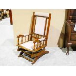 An early 20th century American Bobbin Rocking Chair with upholstered back and seat, turned bobbin