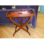 A Georgian style mahogany oval butlers Tray on stand, rectangular centre with brass hinged fold down