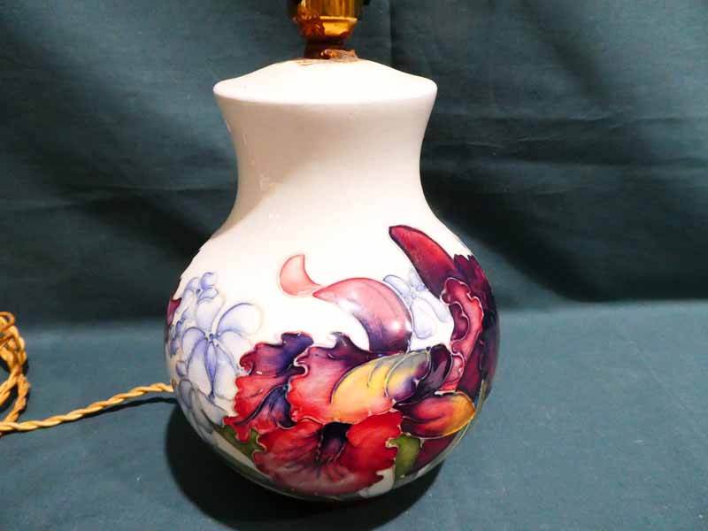 A Moorcroft pottery Table Lamp Base, tubeline decorated with Summer blooms on a cream ground, 20cm