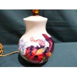 A Moorcroft pottery Table Lamp Base, tubeline decorated with Summer blooms on a cream ground, 20cm