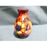 A small Walter Moorcroft pottery Vase of ovoid narrow neck form, tubeline decorated with Anemones on