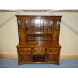 A good reproduction oak 18th century Dresser, ogee moulded cornice above three central shelves,