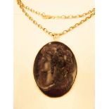 A George V 9ct gold mounted bas relief amethyst glass cameo pendant on later 9ct gold belcher link