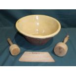 An earthenware Cream Bowl, 32cm diameter, two wooden Potato Clubs and a wooden Scoop (4)