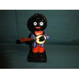 A Carlton Ware hand painted Golly Figure, left handed Banjo Player, colour trial piece, 21cm high