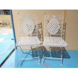 A pair of wrought iron and lattice strapwork folding Garden chairs 97cm high by 35cm wide