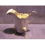 A good quality Edwardian silver Cream Jug, helmet shape with S scroll handle, standing on three