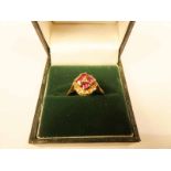 An 18ct gold ruby and cognac diamond cushion cluster ring size O, 4.2g