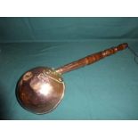 A 19th century copper Ladle, 21cm diameter with 58cm turned wooden handle