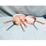 A copper cast iron handled pan and lid by Duval, 23cm diameter and a similar smaller pan also by