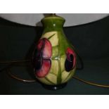 A modern Moorcroft pottery Table Lamp Base, tubeline decorated in red/blue/green with stylised