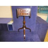 A Regency style mahogany drop flap Side Table, moulded edge rounded rectangular top with hinged drop