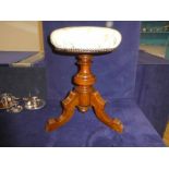 An Edwardian revolving Piano Stool, circular stuff over seat recently upholstered, screw down action