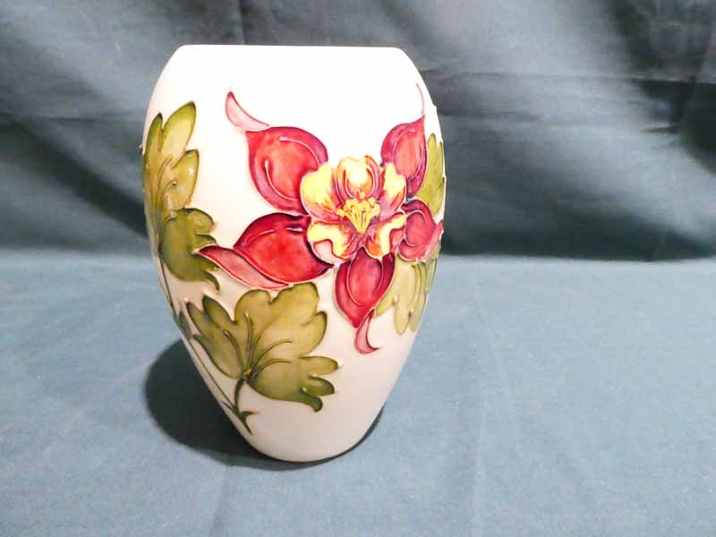 A Moorcroft pottery Vase of ovoid form, tubeline decorated with Hibiscus on a cream ground, 18cm