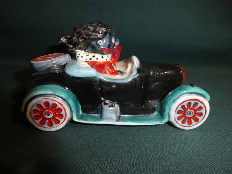 A Carlton Ware hand painted Golly Figure, Driving a Car, trial colourway, 12cm long