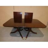 A large reproduction Regency style extending Dining Table, mahogany effect, typical rounded