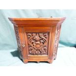 A small 19th century carved oak wall hanging Corner Cabinet, single door enclosing shelved interior,