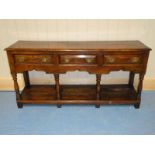 A late 18th century oak Pot Board Dresser Base, moulded edge rectangular two plank top over three