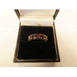 A 9ct gold five stone garnet ring size P, 3.3g (significant wear to the stones)
