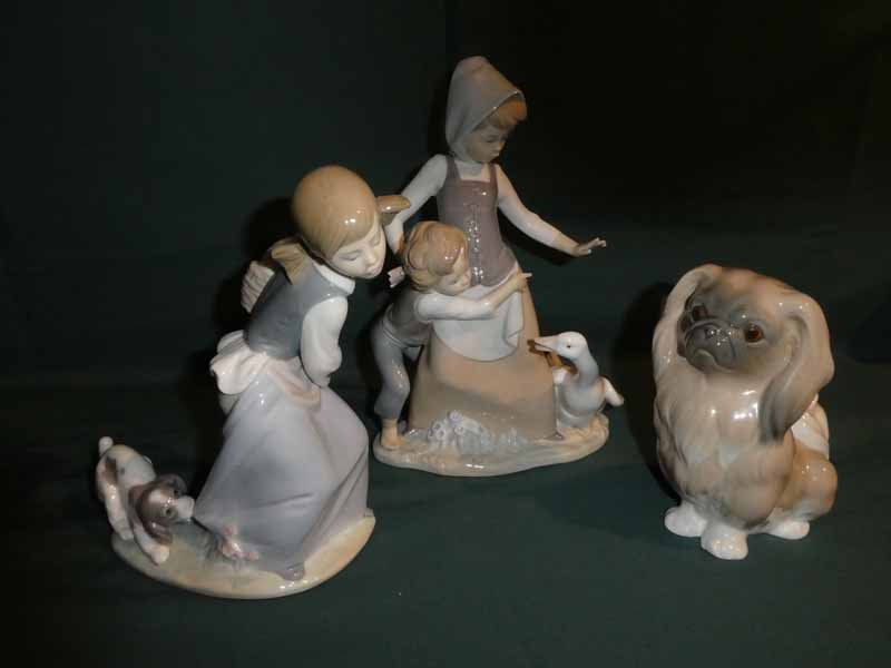 Three Lladro porcelain Figural Models: Boy and Girl with a Goose, 26cm high, Girl with a Dog pulling