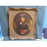 A Victorian oil on canvas portrait of a young boy holding a book, oval panel in square gilt frame,