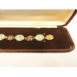 A 14k gold pale green jade panel bracelet, the panels bearing imperial characters 18cm, 9.3g
