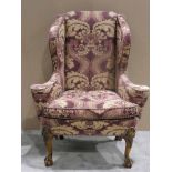 A good quality early 20th century Georgian Style wing back armchair, recently reupholstered in mauve