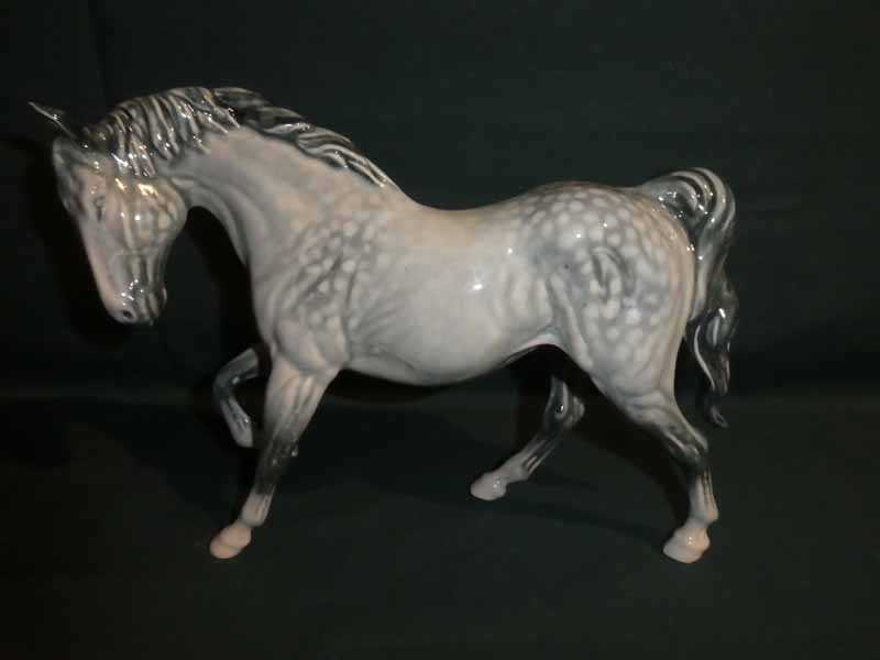 A Beswick Horse, right leg up in unusual Dapple Grey type colourway, 23cm long