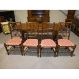 A set of four oak Yorkshire style spindle back Dining Chairs with upholstered pad seats, turned