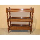 A Victorian mahogany three tier buffet, each rectangular tier galleried to three sides, supported on