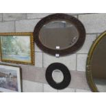 Two oval Wall Mirrors in foliate carved wooden Frames
