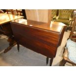 An early 20th century mahogany Pembroke style Dop Leaf Dining Table