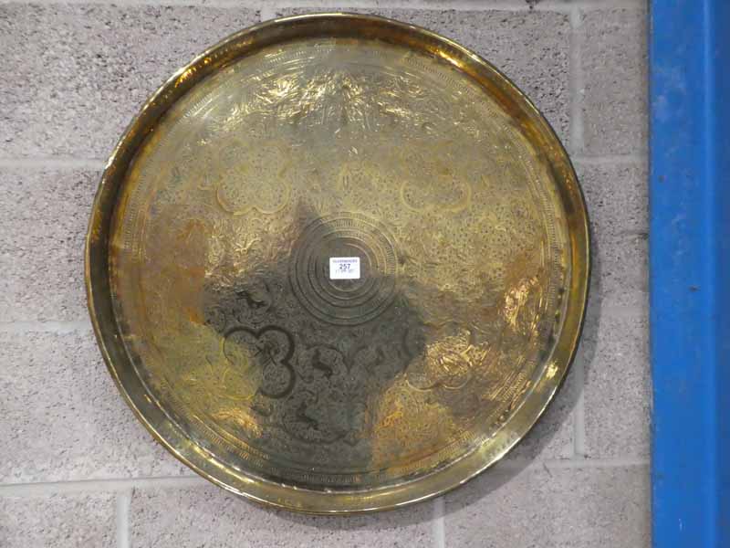 A large Indian brass circular Wall Plaque with embossed decoration and raised edge 68cm diameter