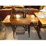 A Singer drophead model Sewing Machine on cast metal treddle base, model number F8821715