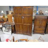 An oak 1970s Bedroom Suite; Double Wardrobe, Tallboy and Dressing Table