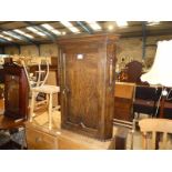 An early 20th century oak flat fronted Corner Wall Cabinet