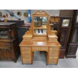 An Edwardian satin walnut Dressing Table with mirrored back incorporating candle sconces and