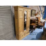 A pine single Wardrobe with central mirror Door, two drawer base