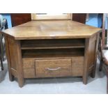 An oak Corner Media Cabinet with integral Shelves and single drawer