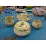 A four piece Avon ware Art Deco Teapot, Sugar and Cream and lidded Bowl