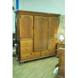 Marsh, Jones, Cribb & Co oak triple Wardrobe with interior mirrored central drawer flanked by