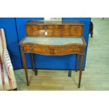 A reproduction Regency style mahogany effect Bonnheur du Jour with low gallery to three sides and